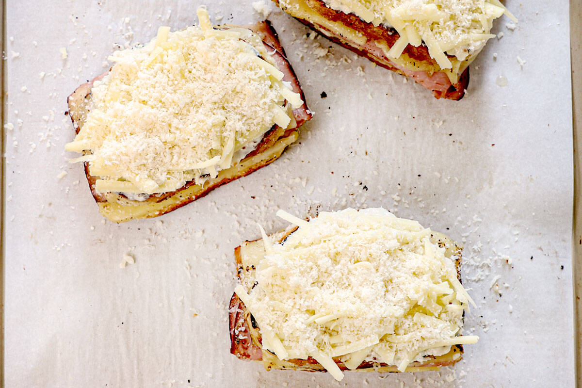 showing how to make croque monsieur recipe by adding shredded Gruyere and Parmesan 