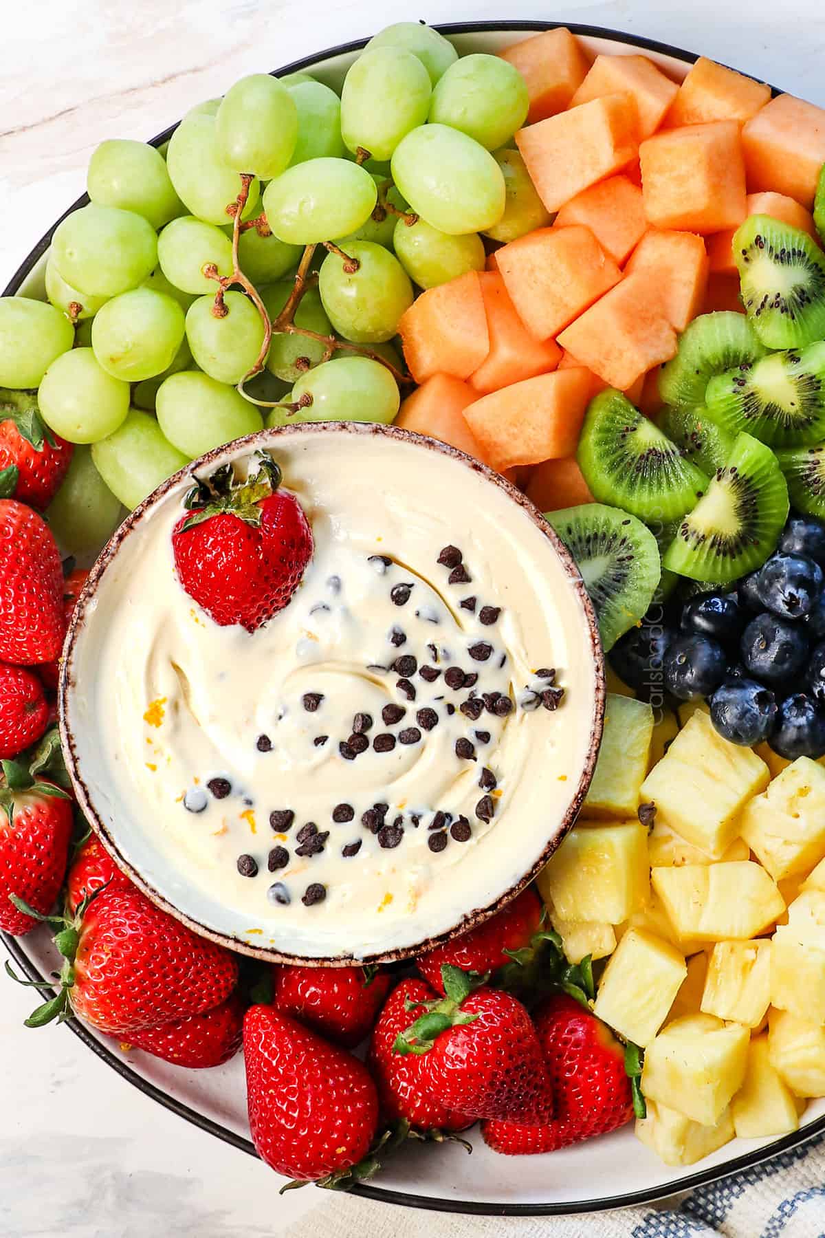 top view of fruit dip recipe served on a platter with a variety of fruits 