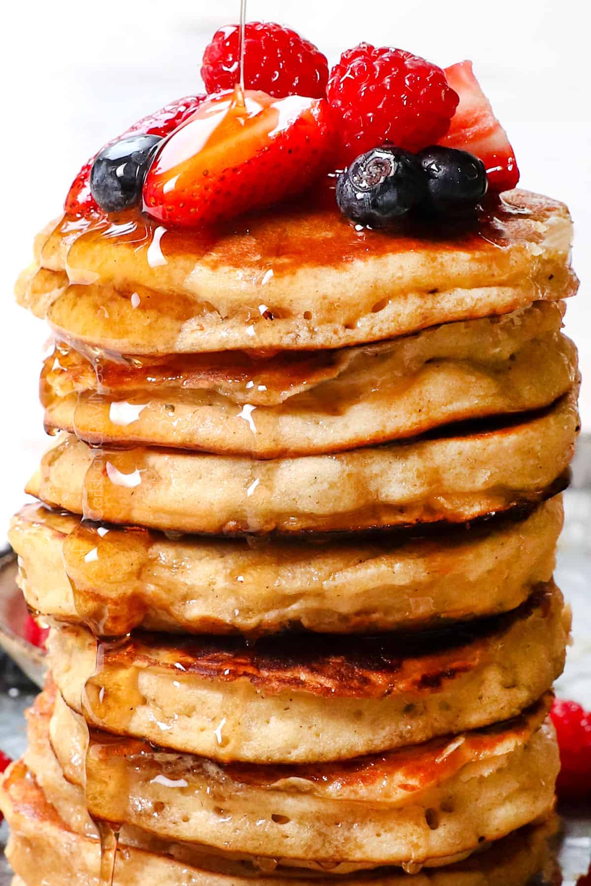 showing how to serve fluffy pancakes by drizzling with syrup