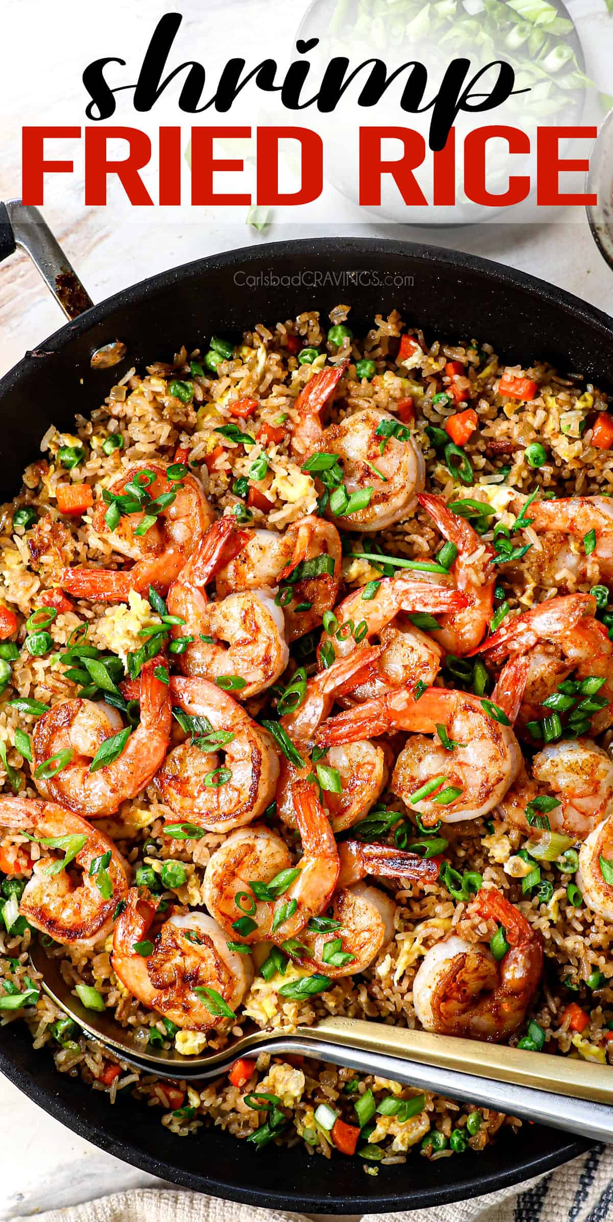 top view of shrimp fried rice in a skillet garnished with green onions showing the juicy golden shrimp