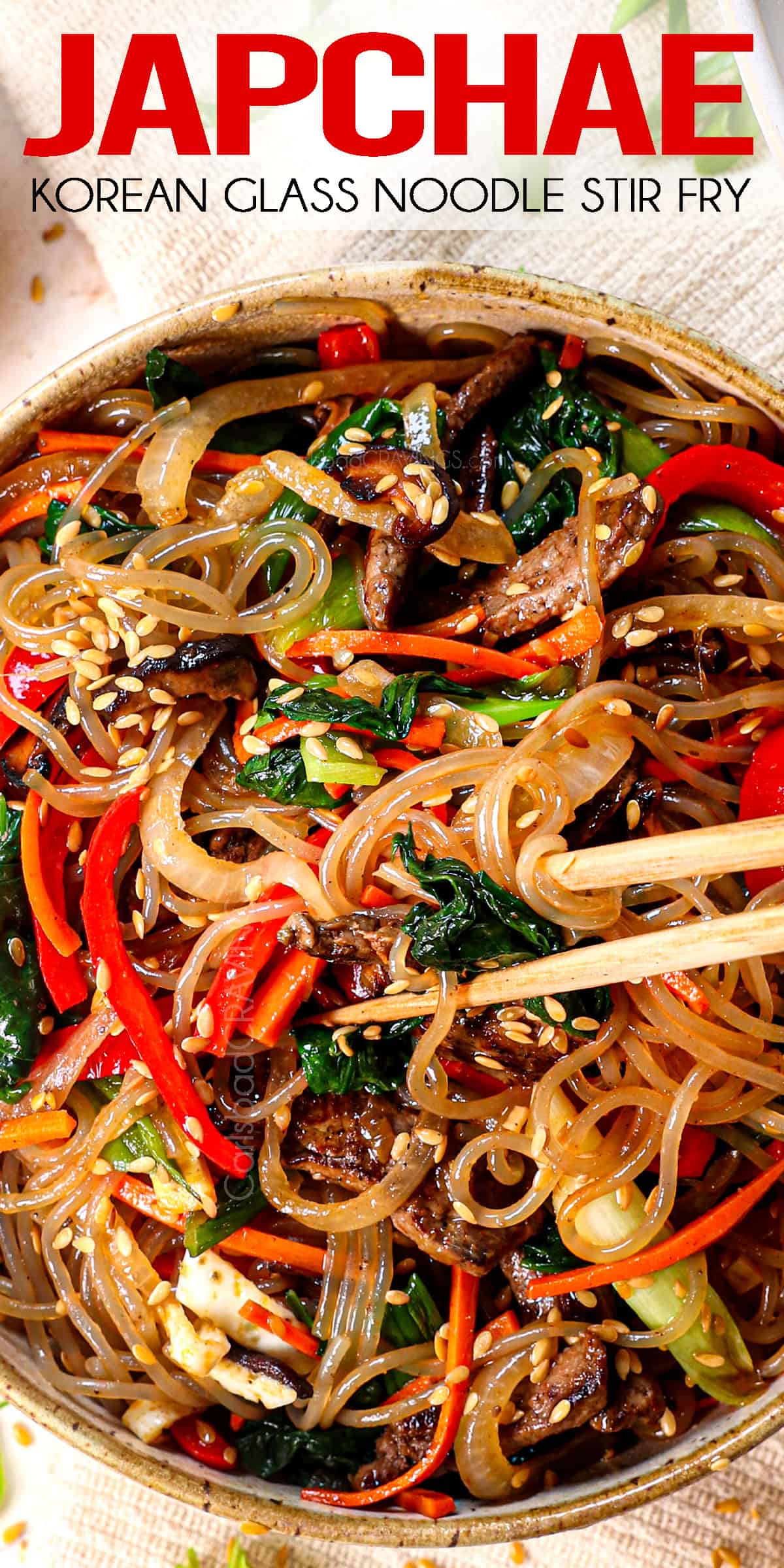 top view of Japchae in a bowl being eating with chopsticks