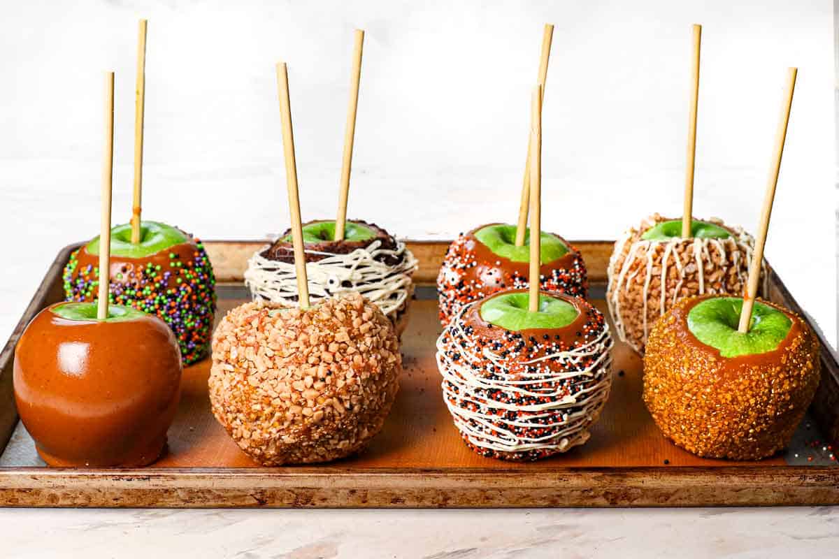 showing how to make caramel apples by cooling on a baking sheet lined with a silicone baking mat