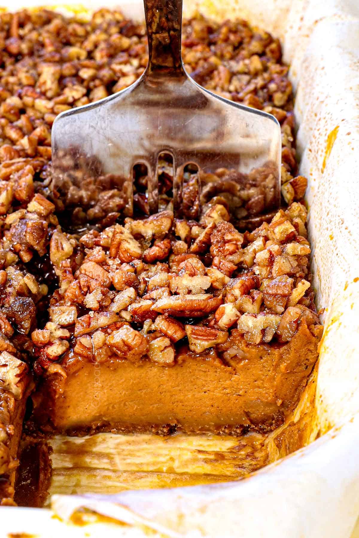 up close of serving pumpkin pie bars recipe by serving up with a spatula