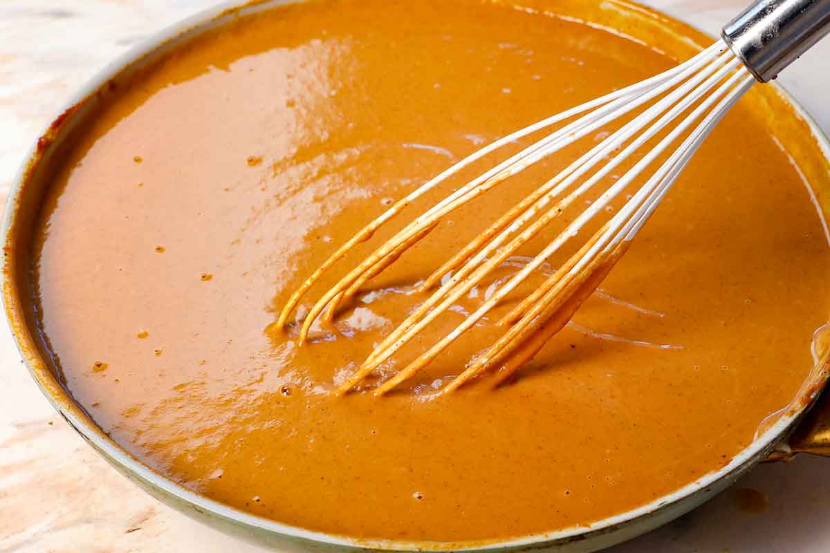 showing how to make pumpkin pie bars by whisking the filling ingredients together until smooth