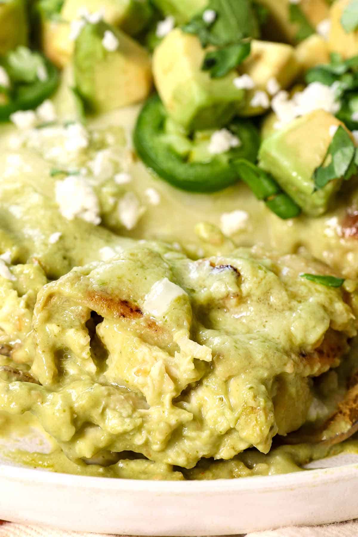 up close of a bite of enchiladas suiza showing how creamy and cheesy they are