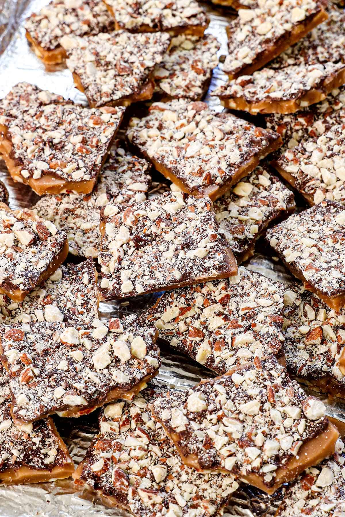 almond roca candy broken apart on a baking sheet