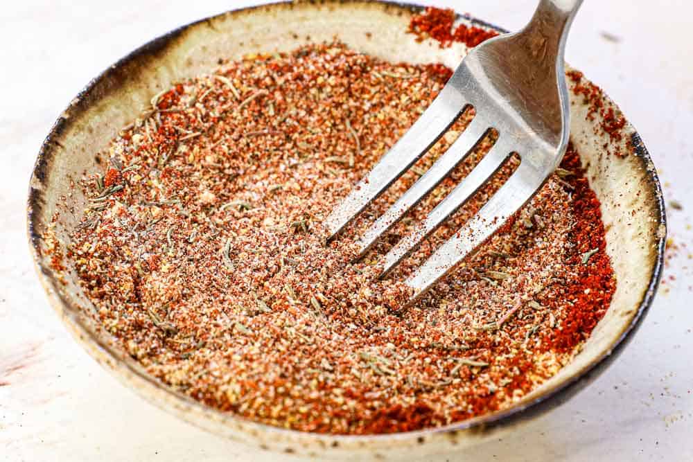 showing how to make hot honey chicken recipe by whisking the spices together in a bowl