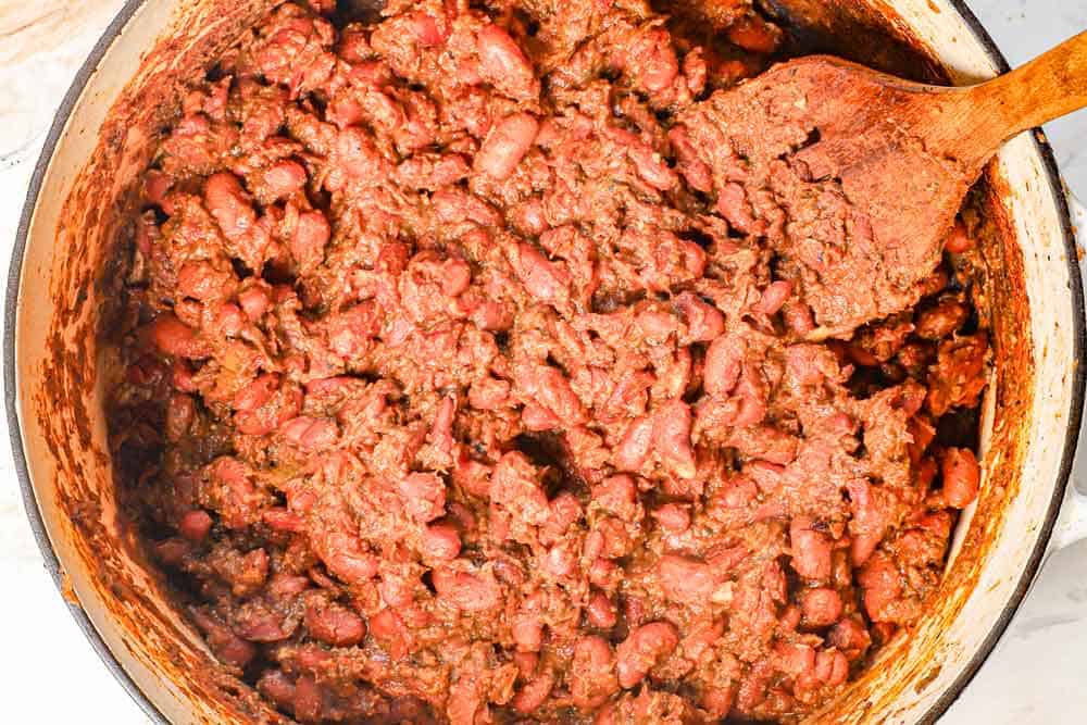 showing how to make red beans and rice by simmering until the beans are tender and creamy