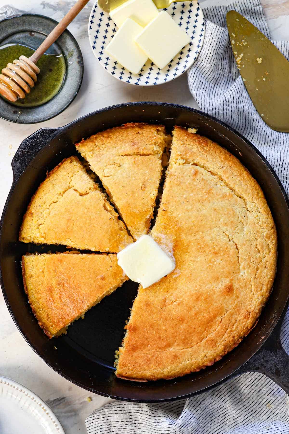 top view of cast iron skillet cornbread recipe with butter on top