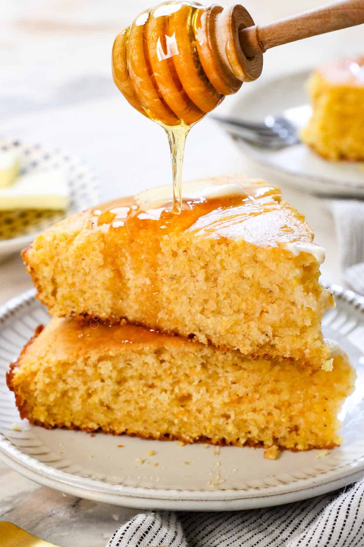showing how to serve cornbread recipe by drizzling the skillet cornbread slices with honey