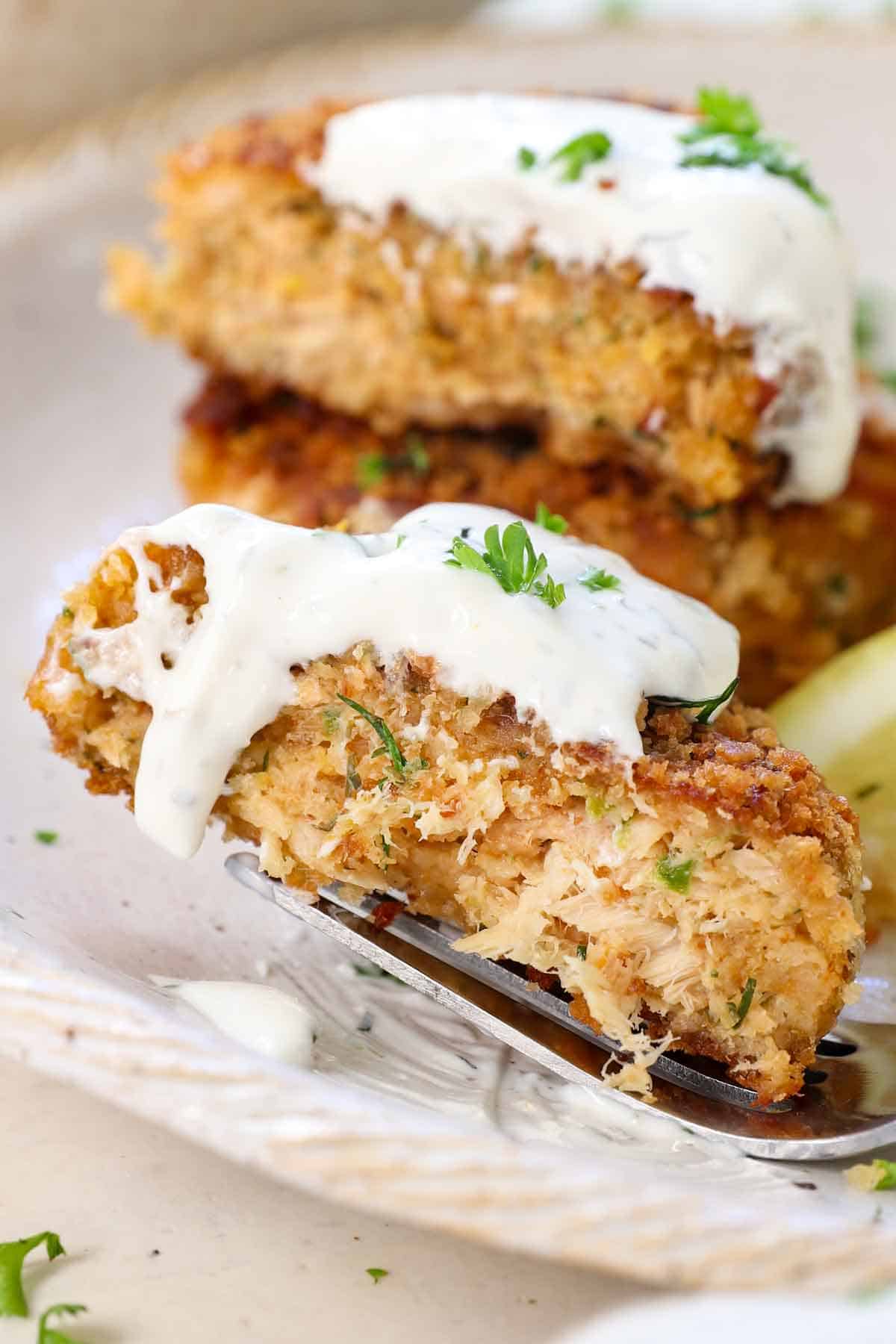 up close of salmon croquette sliced in half showing the juicy interior