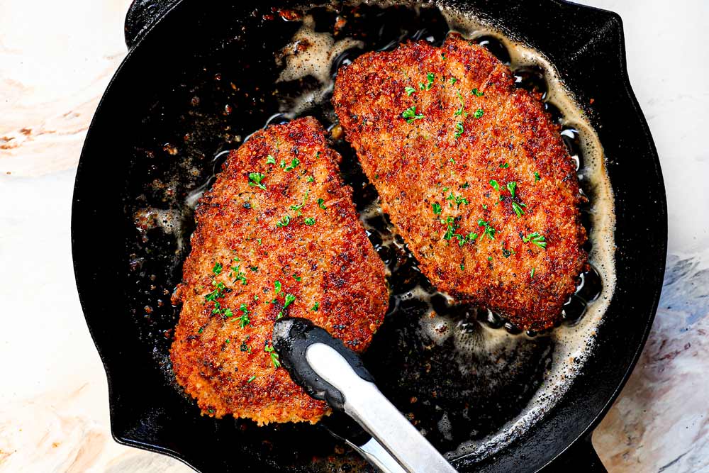 showing how to make Chicken Milanese by pan frying the breaded chicken cutlets in oil