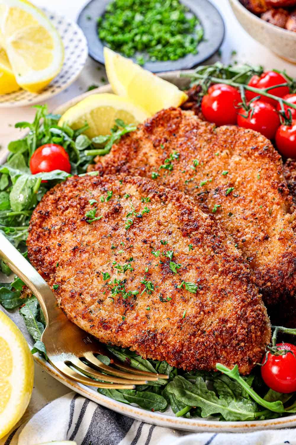 showing how to make chicken Milanese cooking the chicken until crispy