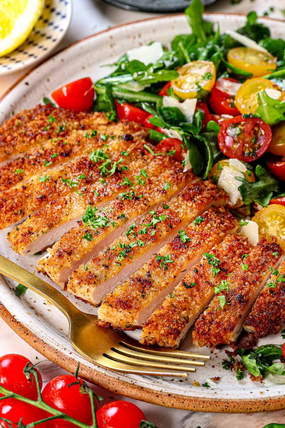Chicken Milanesa sliced on a plate showing how crispy it is