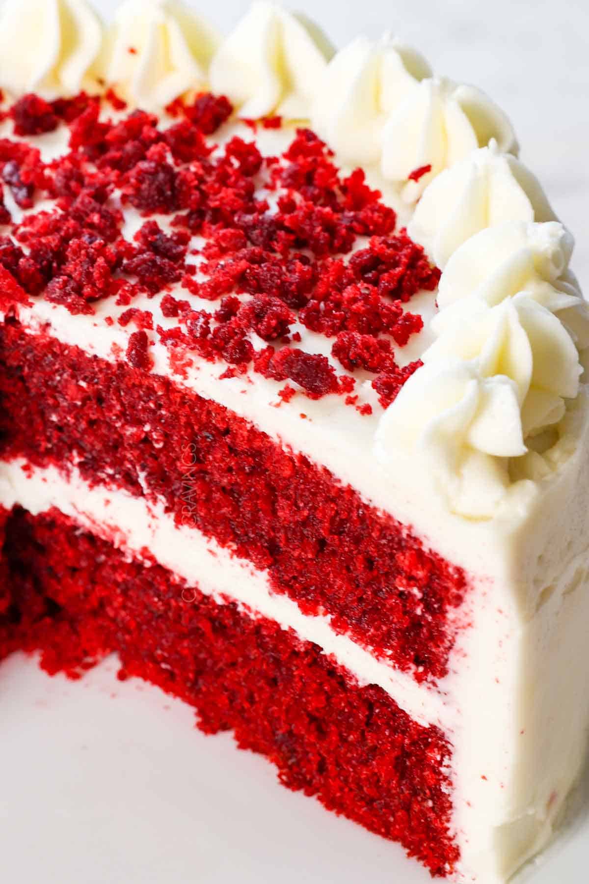 up close of homemade cream cheese frosting on red velvet cake showing how thick and stable it is