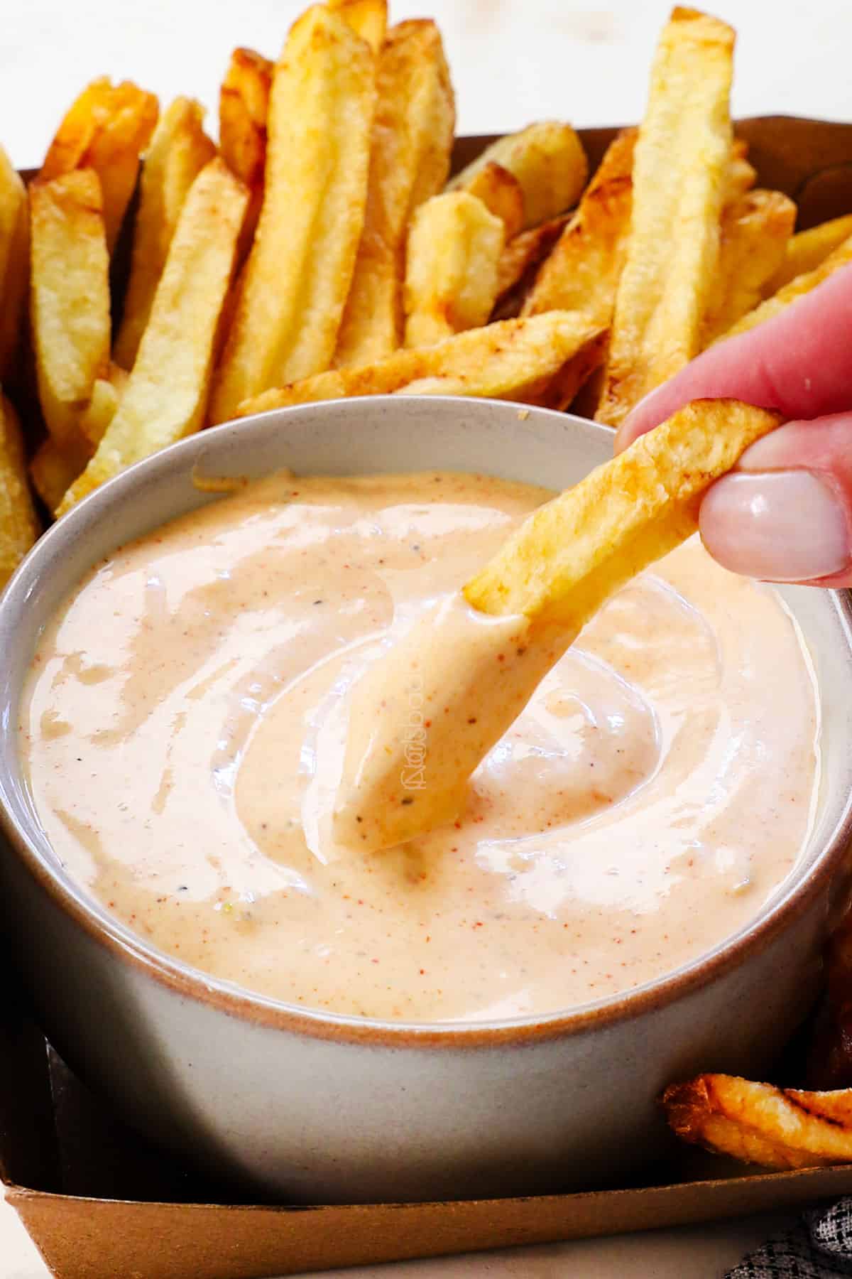 up close of dipping French fry in fry sauce showing how creamy it is