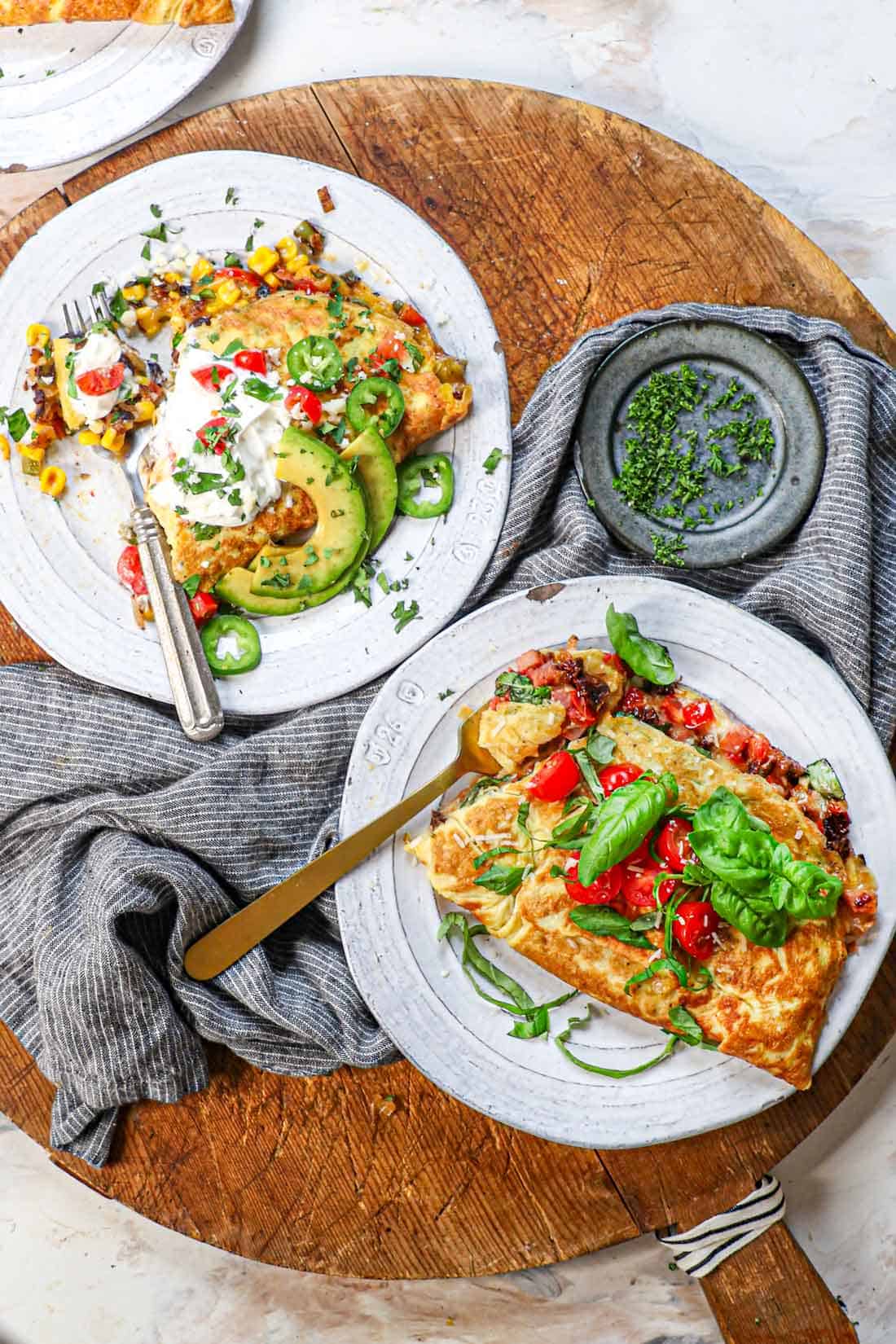 top view of serving omelet garnished with tomatoes and basil