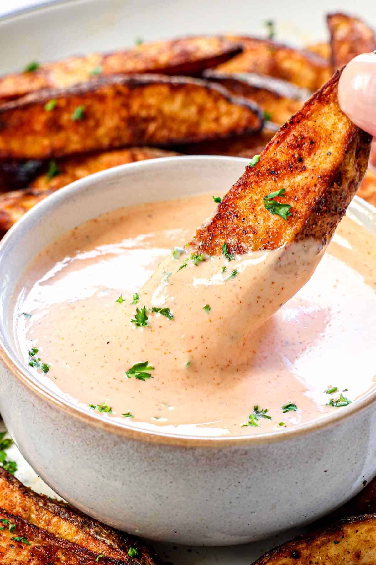 up close of dipping French fry in fry sauce showing how creamy it is