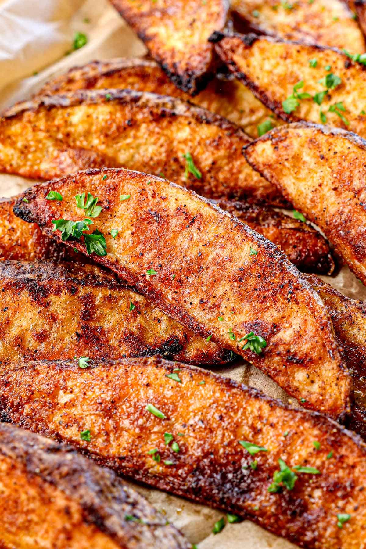 up close of potato wedges recipe showing the seasoning and how crispy they are