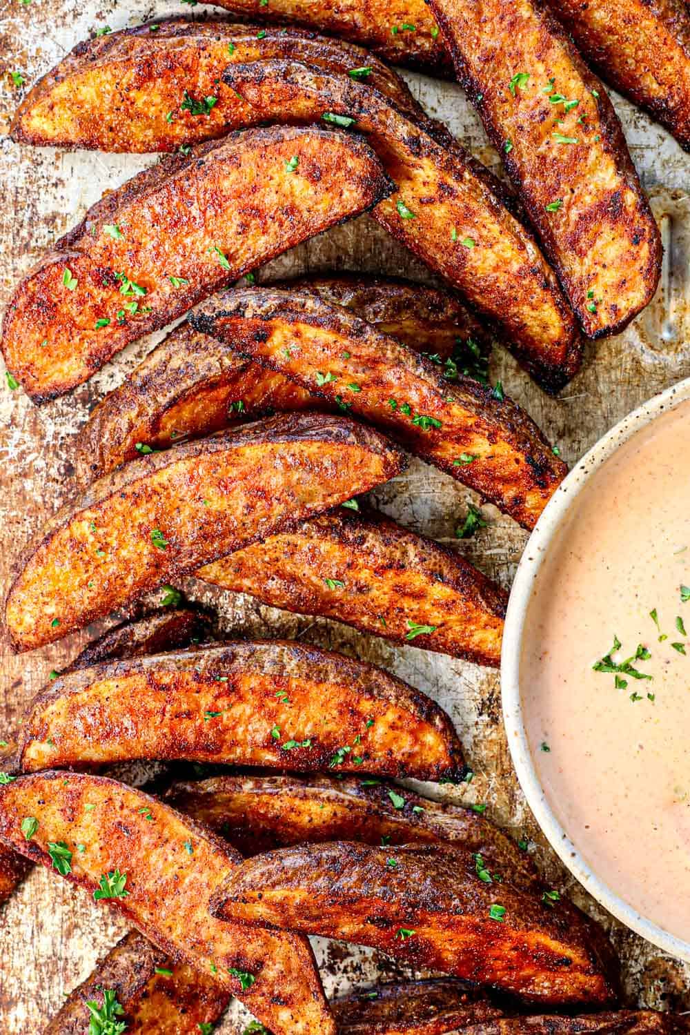 showing how to make potato wedges by baking in the oven until golden brown and crunchy