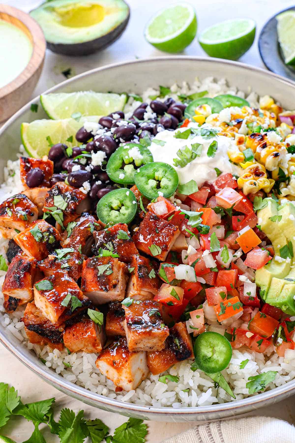 honey chipotle chicken served over rice, with black beans, corn, tomatoes, and avocados