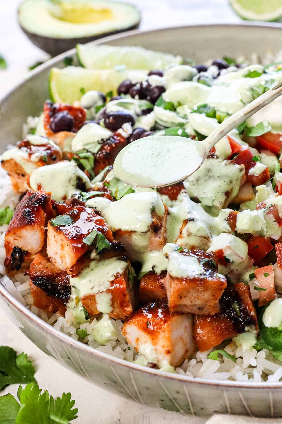 showing how to make chipotle honey chicken by drizzling with cilantro lime dressing