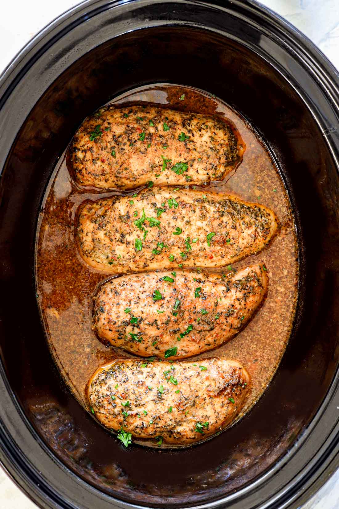 showing how to make crockpot chicken breasts by cooking them until cooked through