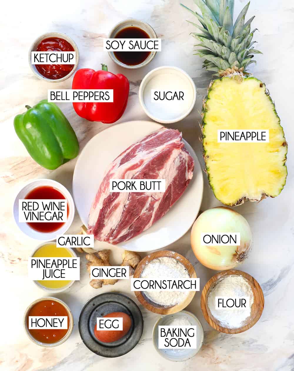 sweet and sour pork ingredients: pork butt, pineapple, bell peppers, soy sauce, ketchup, red wine vinegar, sugar, cornstarch, flour, egg, baking soda, garlic, ginger