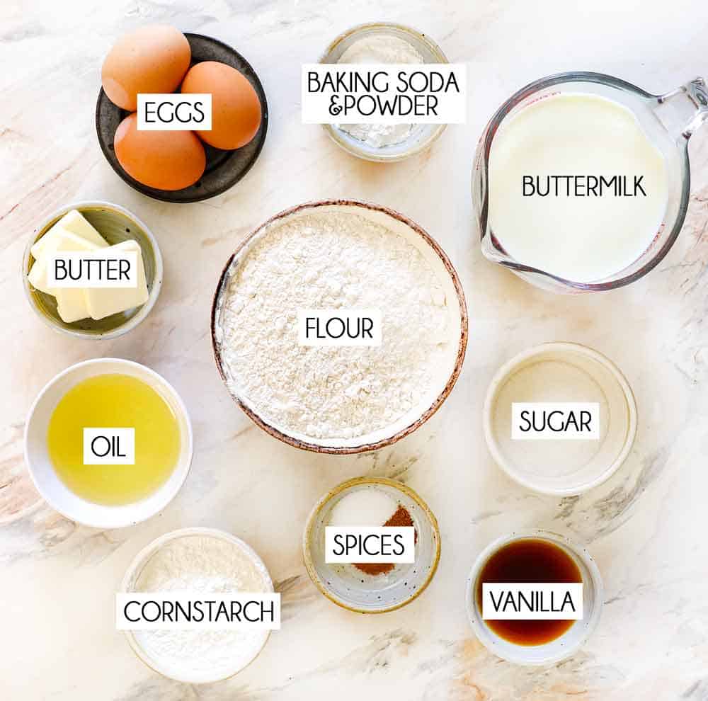 top view of Belgian waffle recipe ingredients: flour, oil, eggs, baking powder, baking soda, butter, buttermilk, cornstarch, vanilla, cinnamon, salt