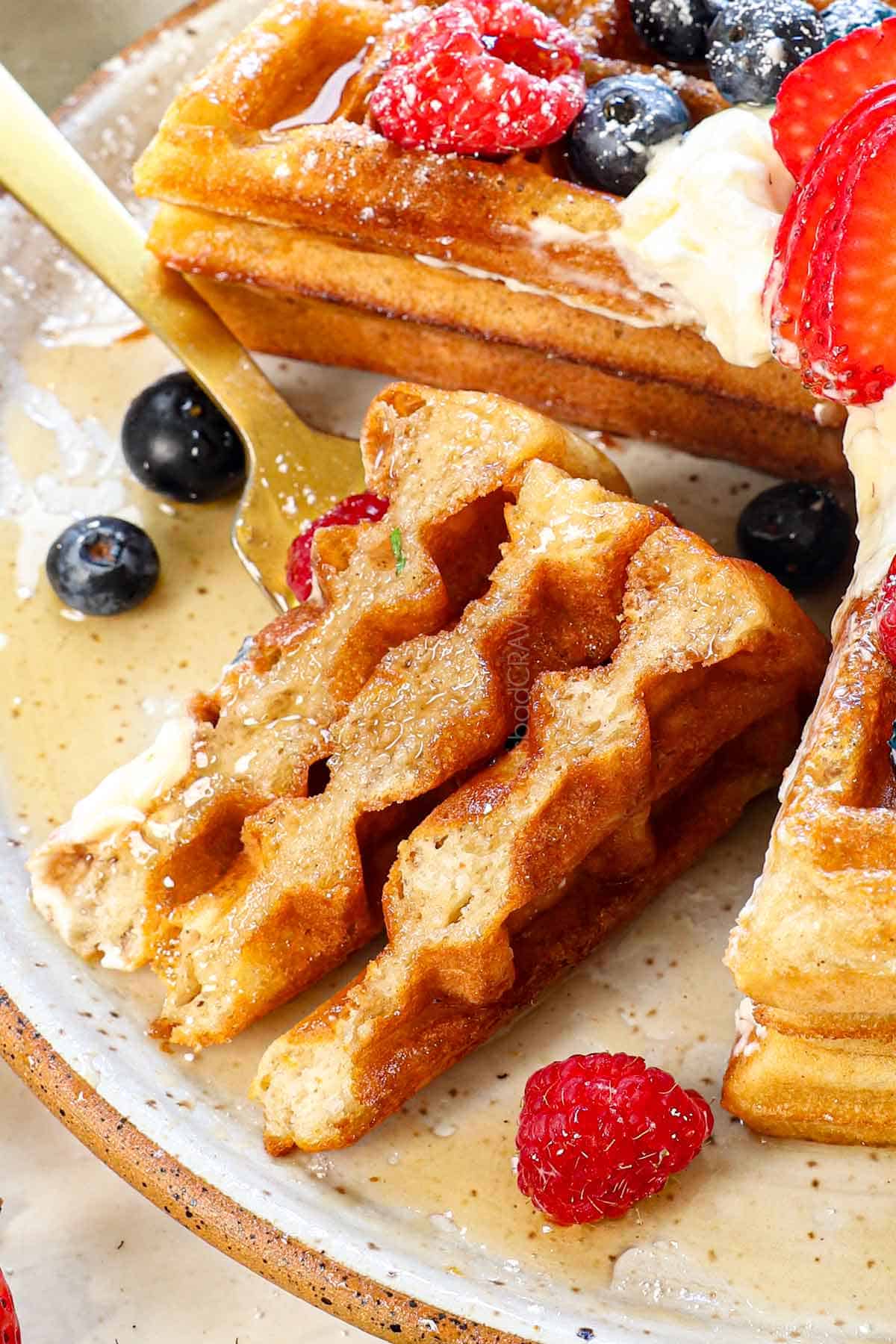 up close of a bite of Belgian waffles recipe showing the crispy exterior and fluff interior