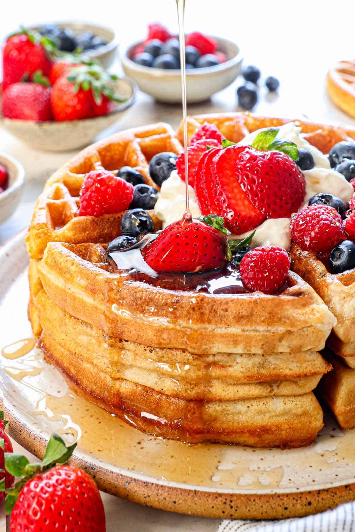 showing how to make Belgian waffles by drizzling with syrup to serve