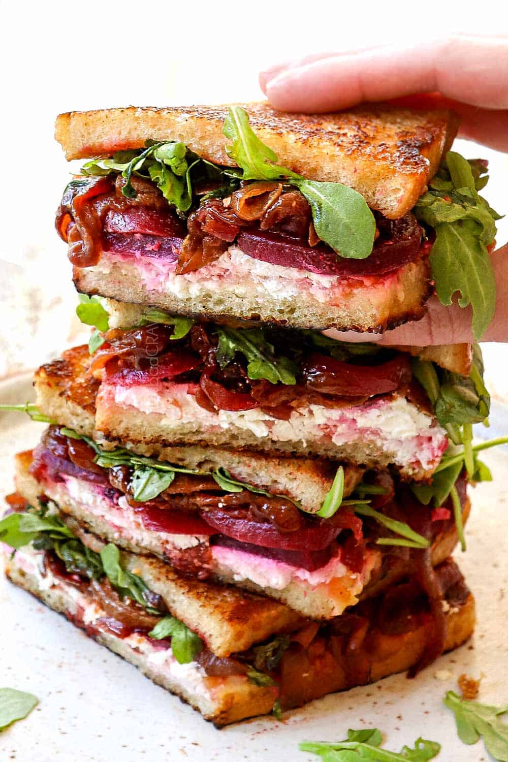 showing how to serve caramelized onions recipe in a grilled cheese sandwich