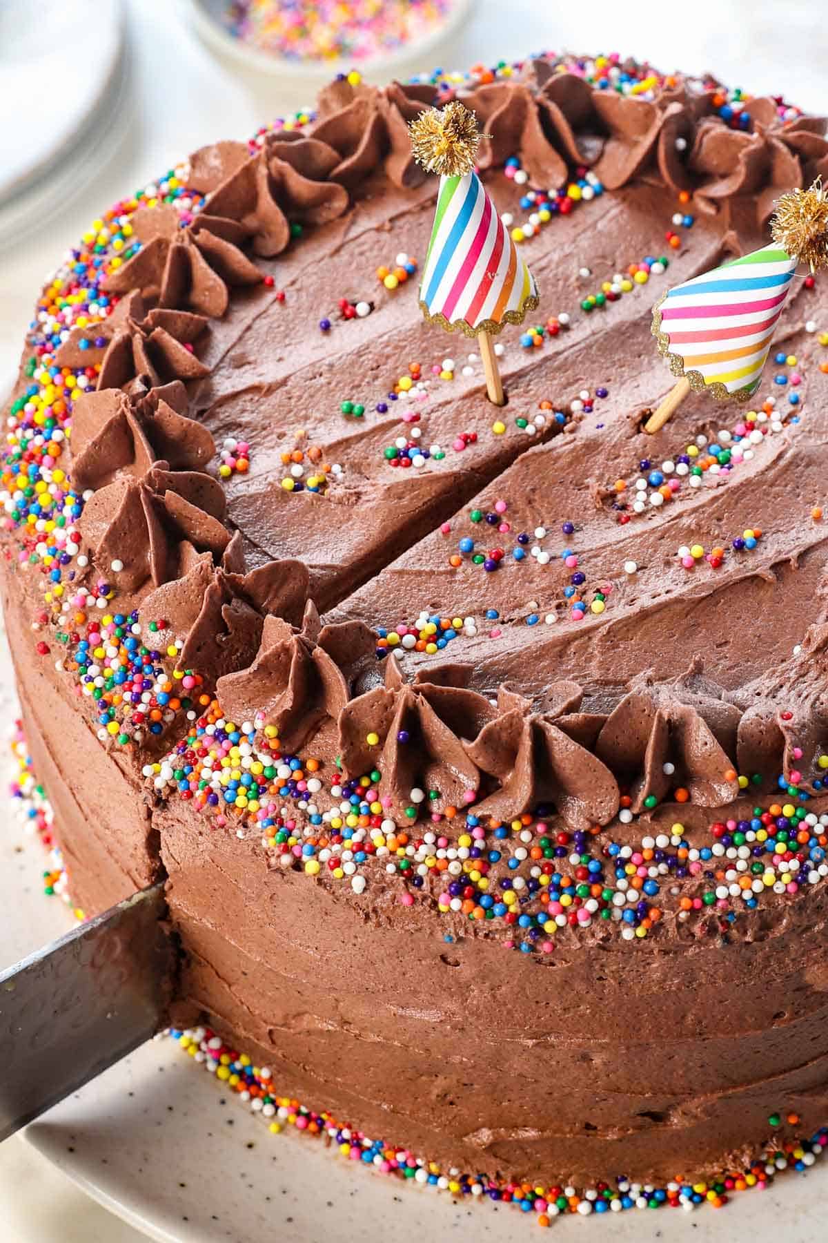 frosting a cake with chocolate frosting