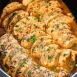 top view of crockpot chicken breasts sliced in a crockpot