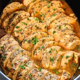 top view of crockpot chicken breasts sliced in a crockpot