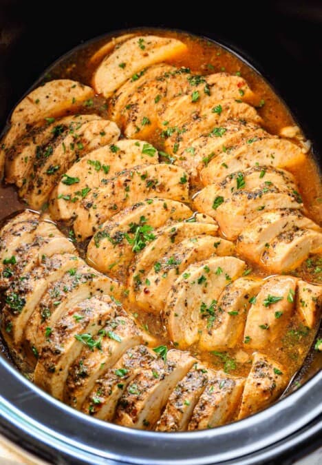 top view of crockpot chicken breasts sliced in a crockpot
