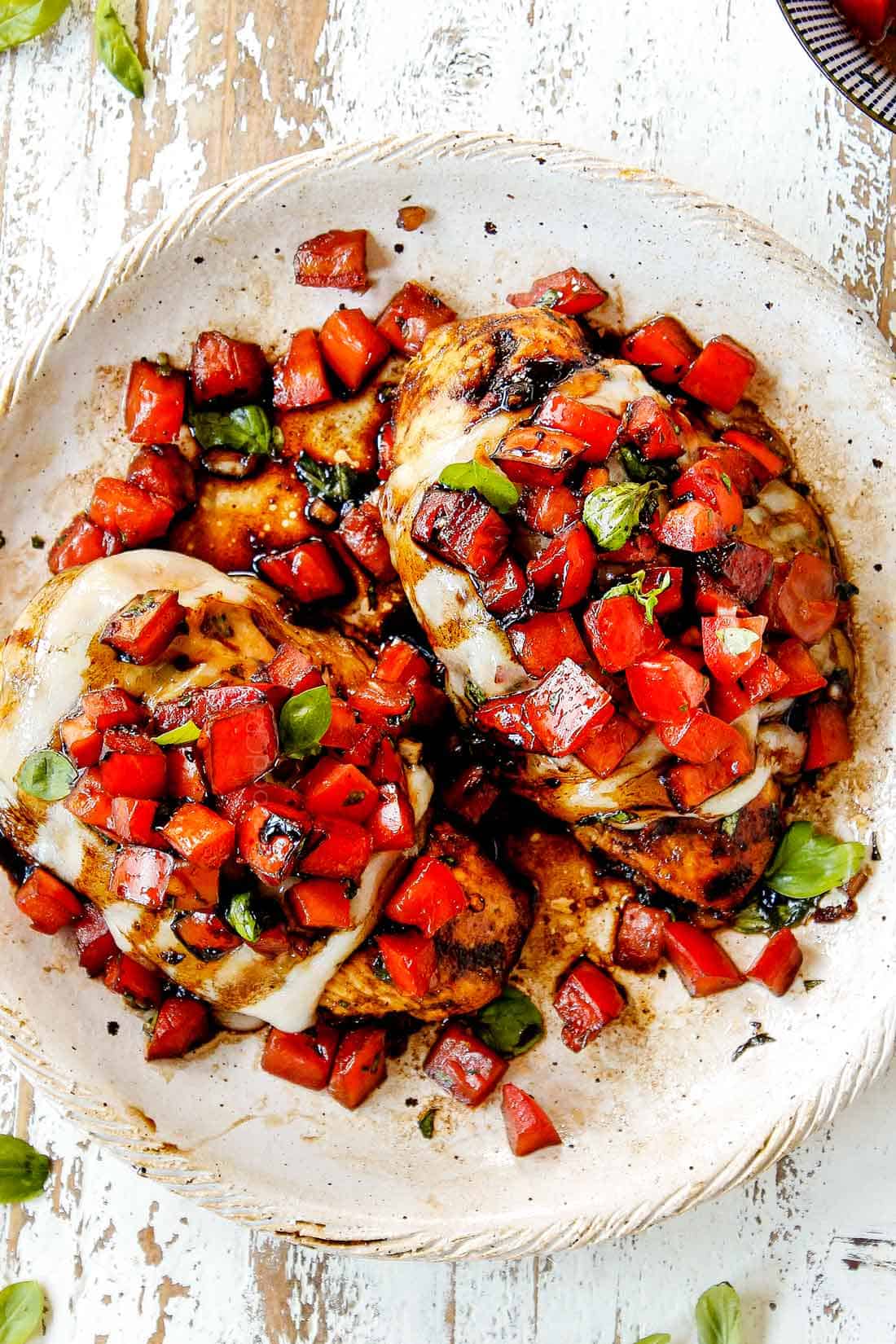 showing how to use balsamic glaze recipe (balsamic reduction) by drizzling over bruschetta chicken