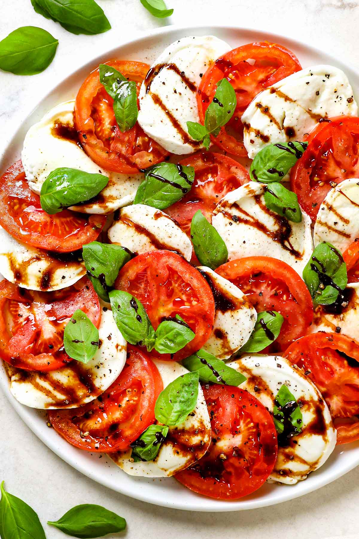 showing how to use balsamic glaze recipe (balsamic reduction) by drizzling over Caprese