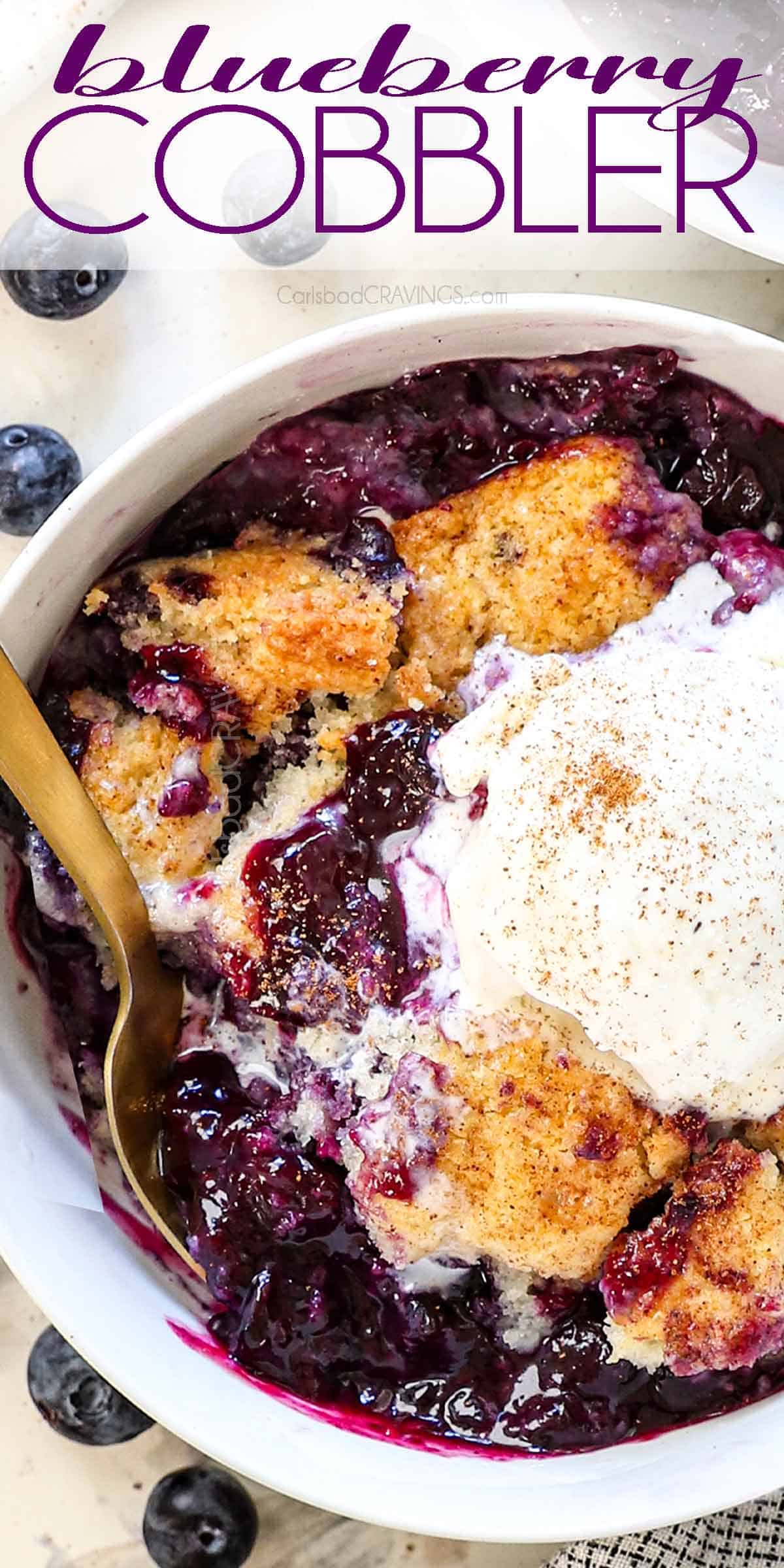 top up close view of a bowl of blueberry cobbler showing the biscuit topping and juicy berries served with vanilla ice cream