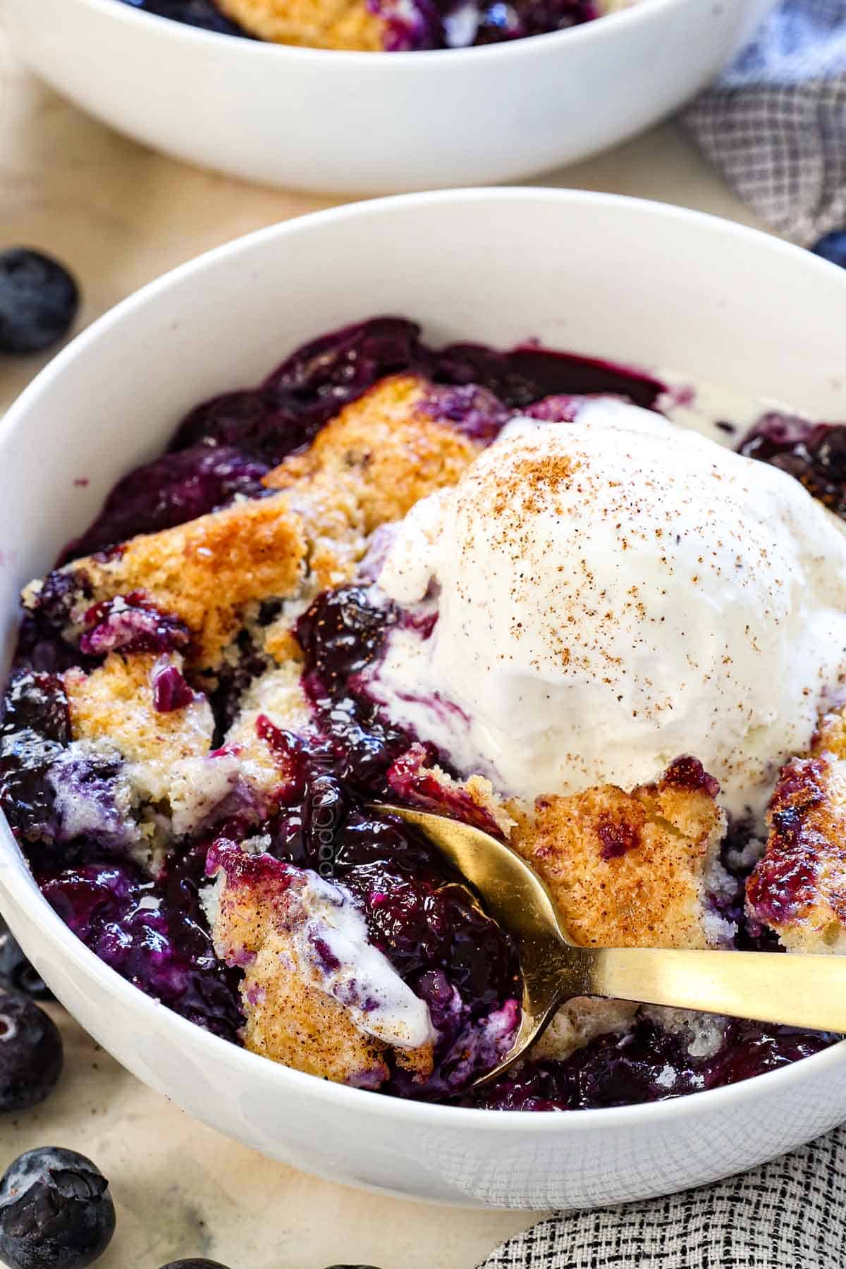 easy blueberry cobbler served in a bowl with ice cream