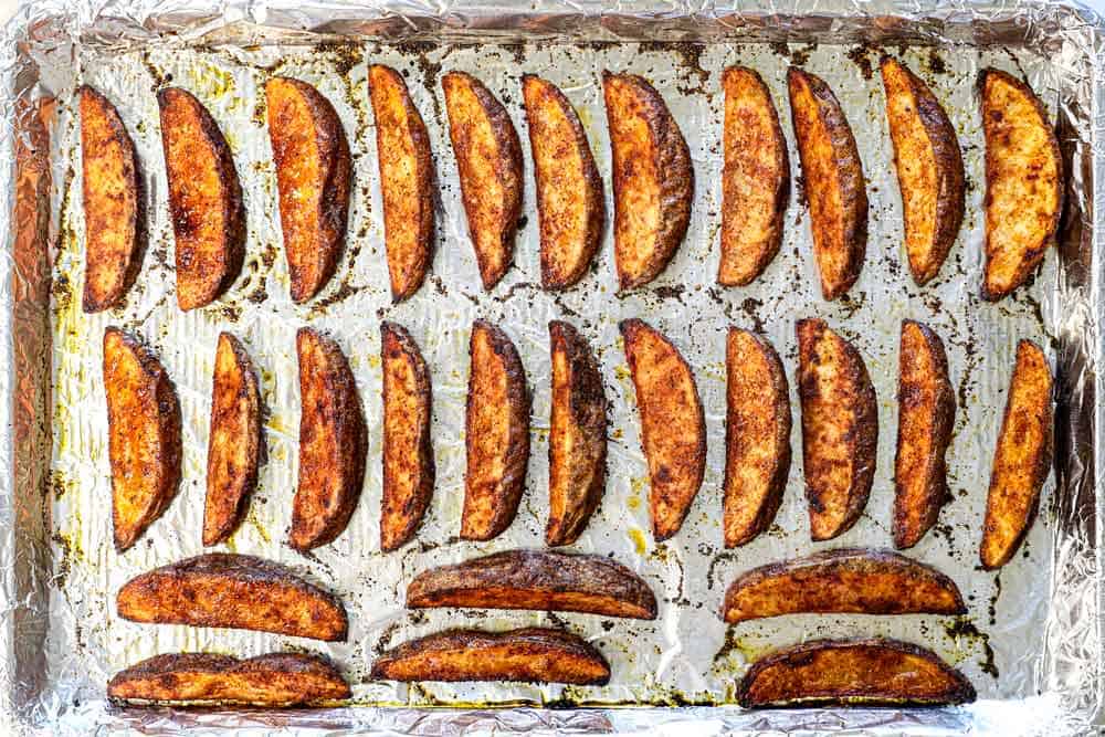 showing how to make burger bowls by baking potato wedges until crispy