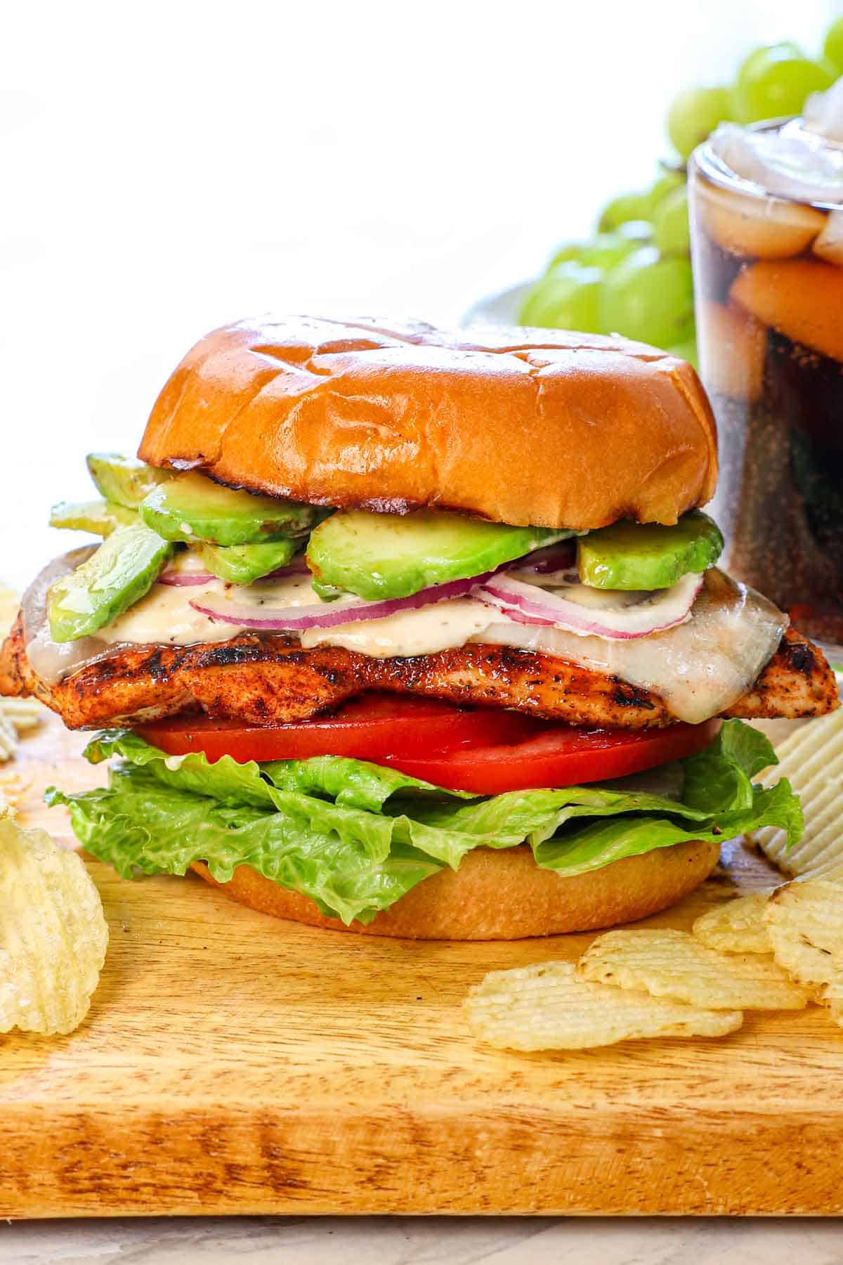 showing the finished assembled chicken sandwich on a cutting board