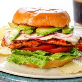 showing the finished assembled chicken sandwich on a cutting board