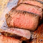 up close of sliced reverse sear steak showing the perfectly even cooking to the exact medium-rare temperature