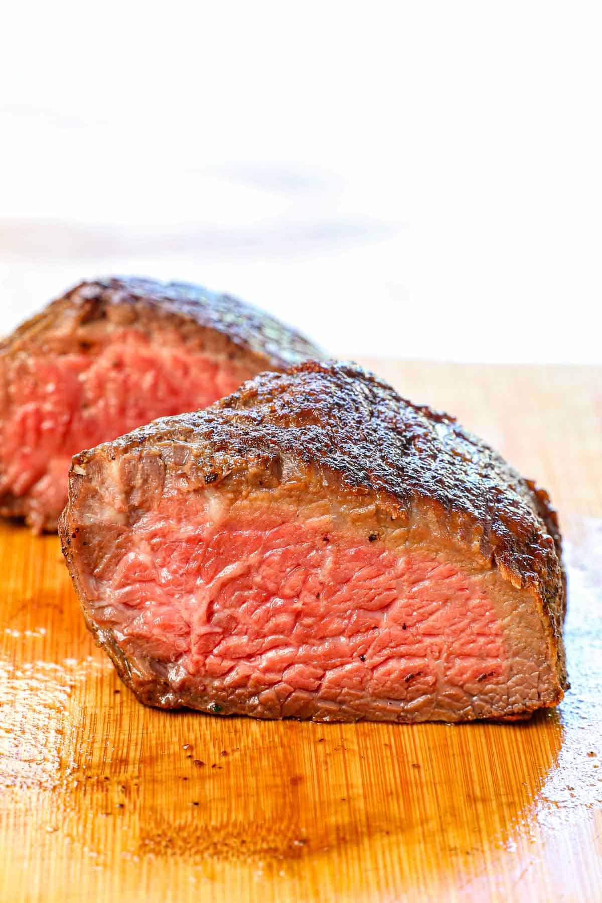 up close reverse sear steak recipe cut in half showing the perfect steak temperature