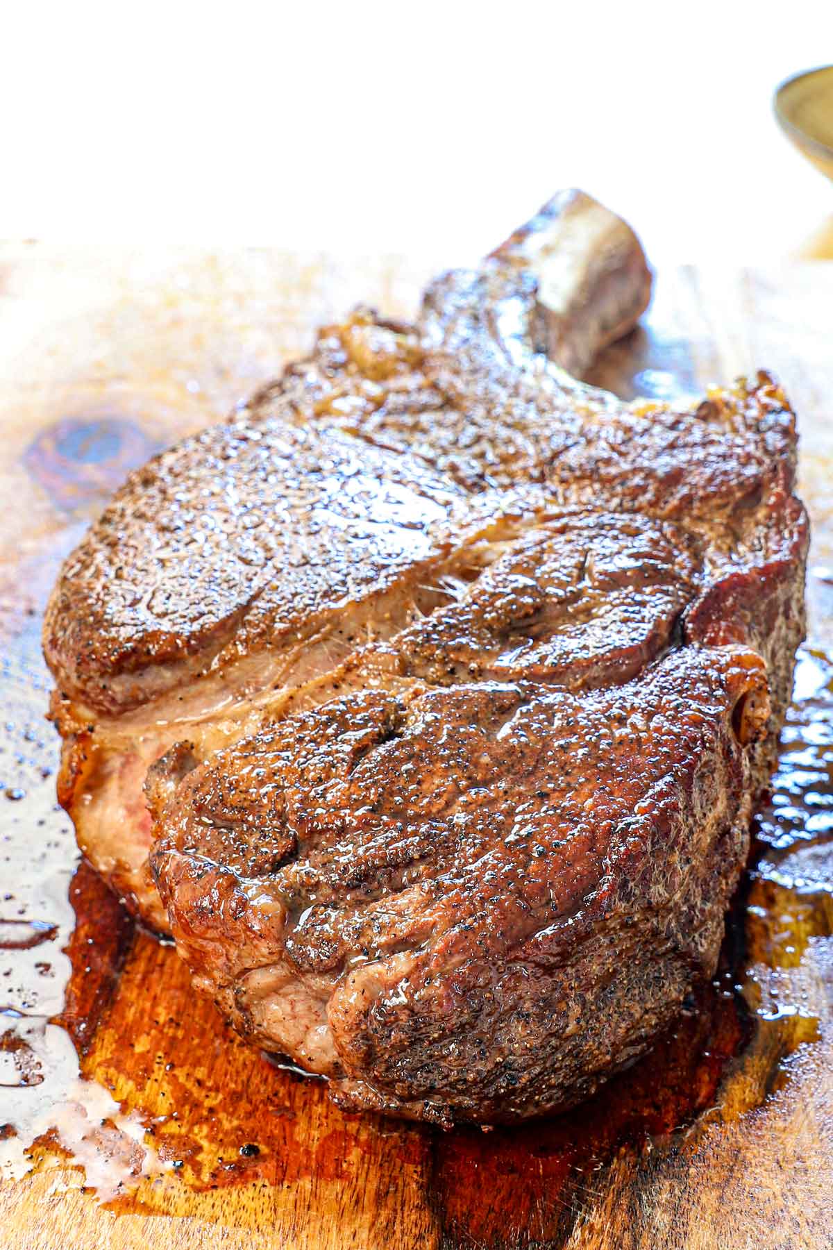 showing how to reverse sear steak by resting the steak on a cutting board before slicing, also showing the beautiful sear
