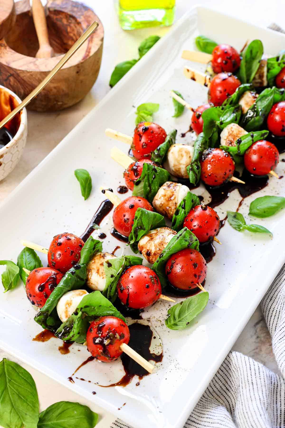 Caprese Skewer recipe lined on up on white serving platter