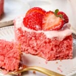 strawberry sheet cake with a bite taken out showing the inside of the fluffy cake