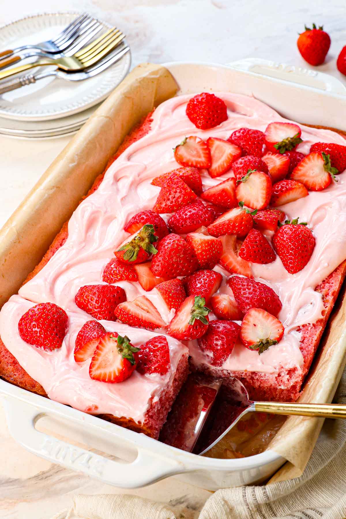 picking up a slice of best strawberry cake to serve
