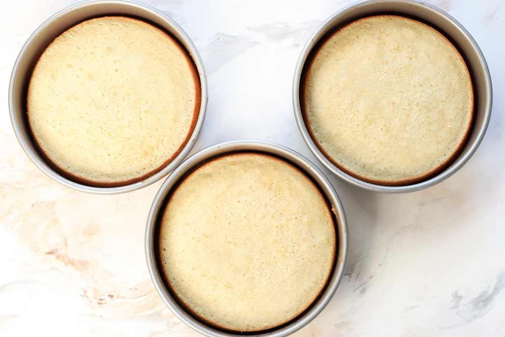 showing how to make yellow cake from scratch by baking in three 8-inch pans, then cooling